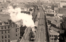 Newcastle upon Tyne. Train from Alnmouth is pulling into Newcastle Central. Manors Station is seen in the distance, 1954